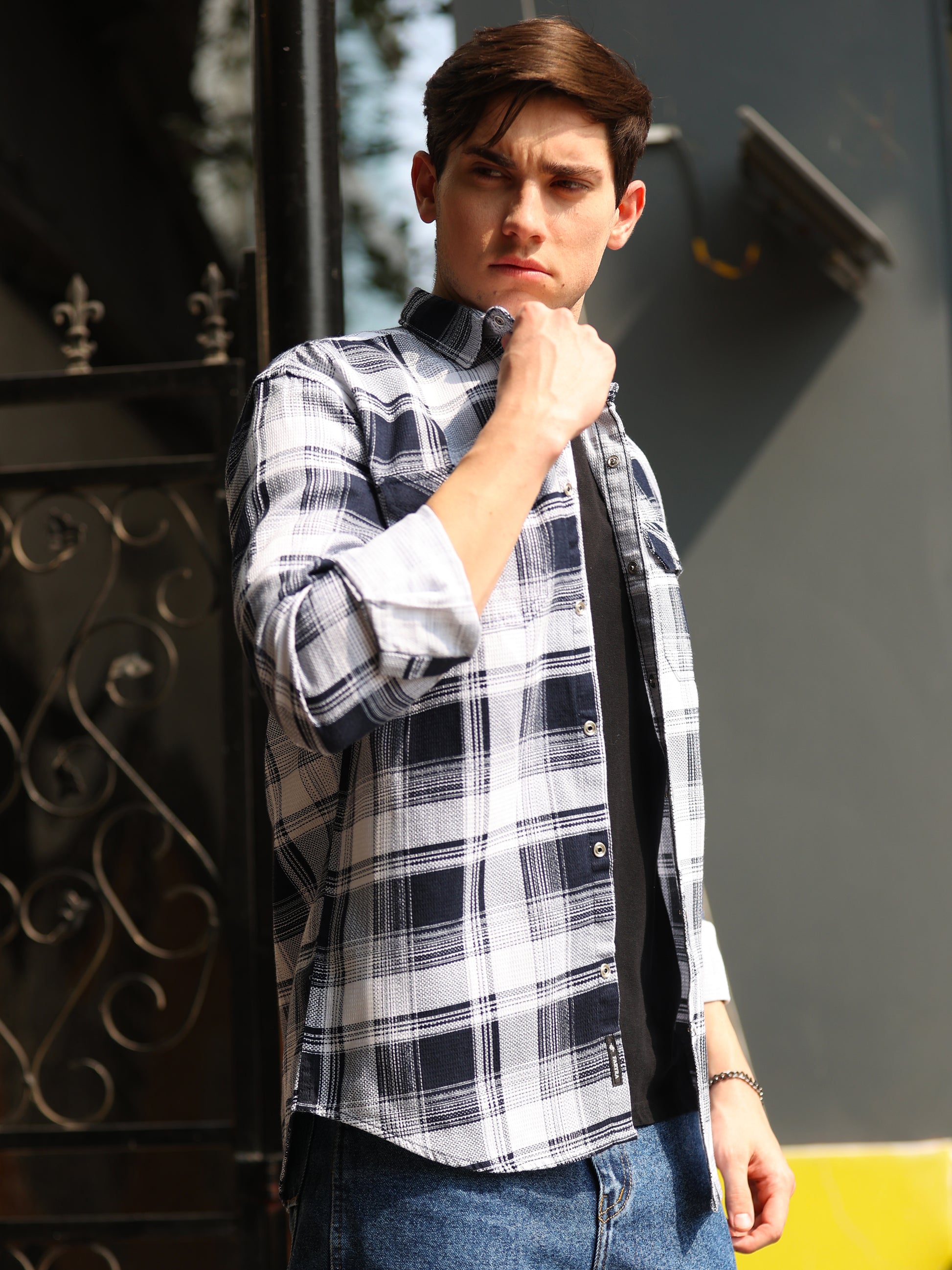 Casual men's black white checks shirt paired with denim jeans