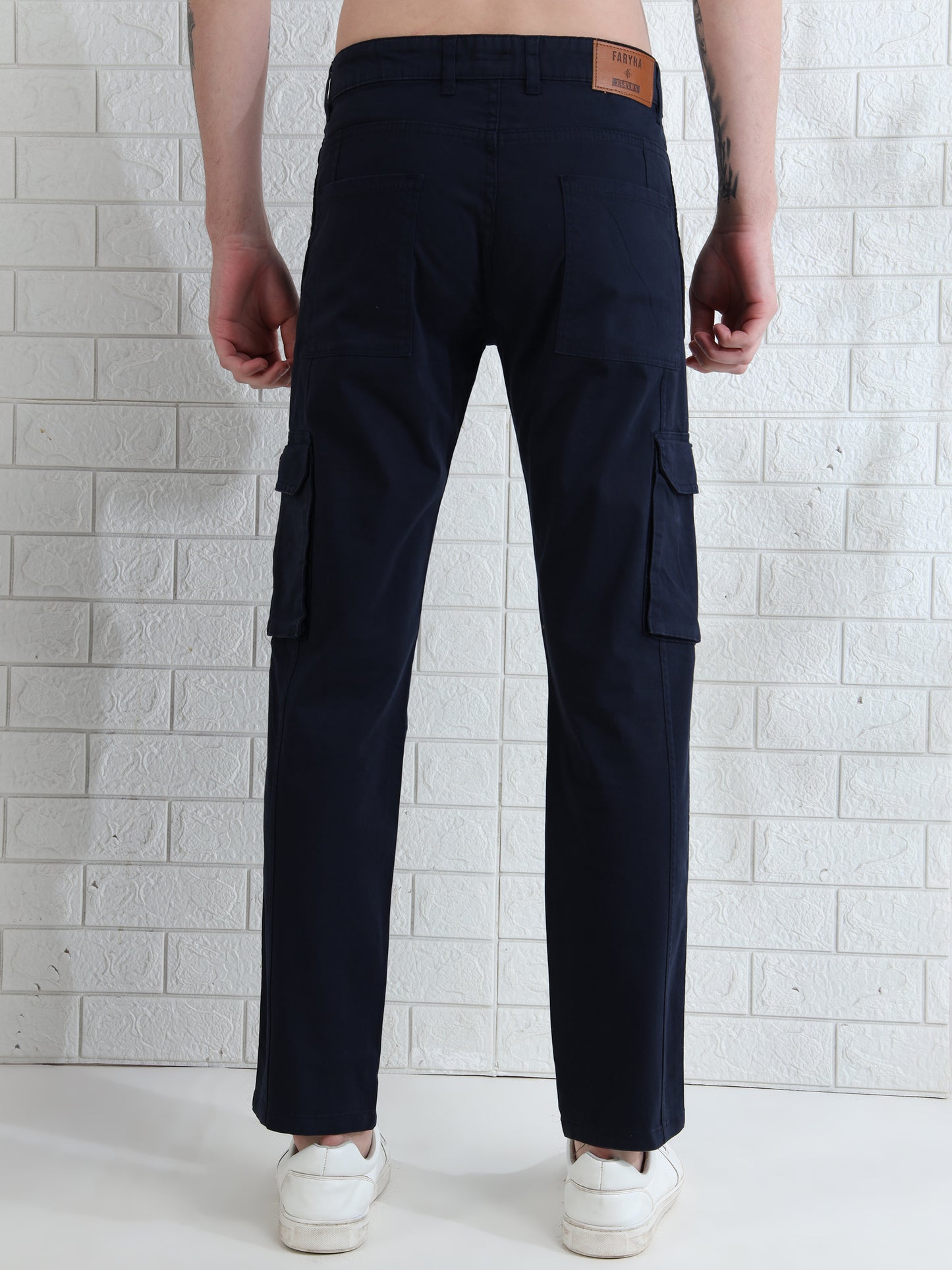 Men's navy blue cotton cargo pants with side flap pockets and slim fi
