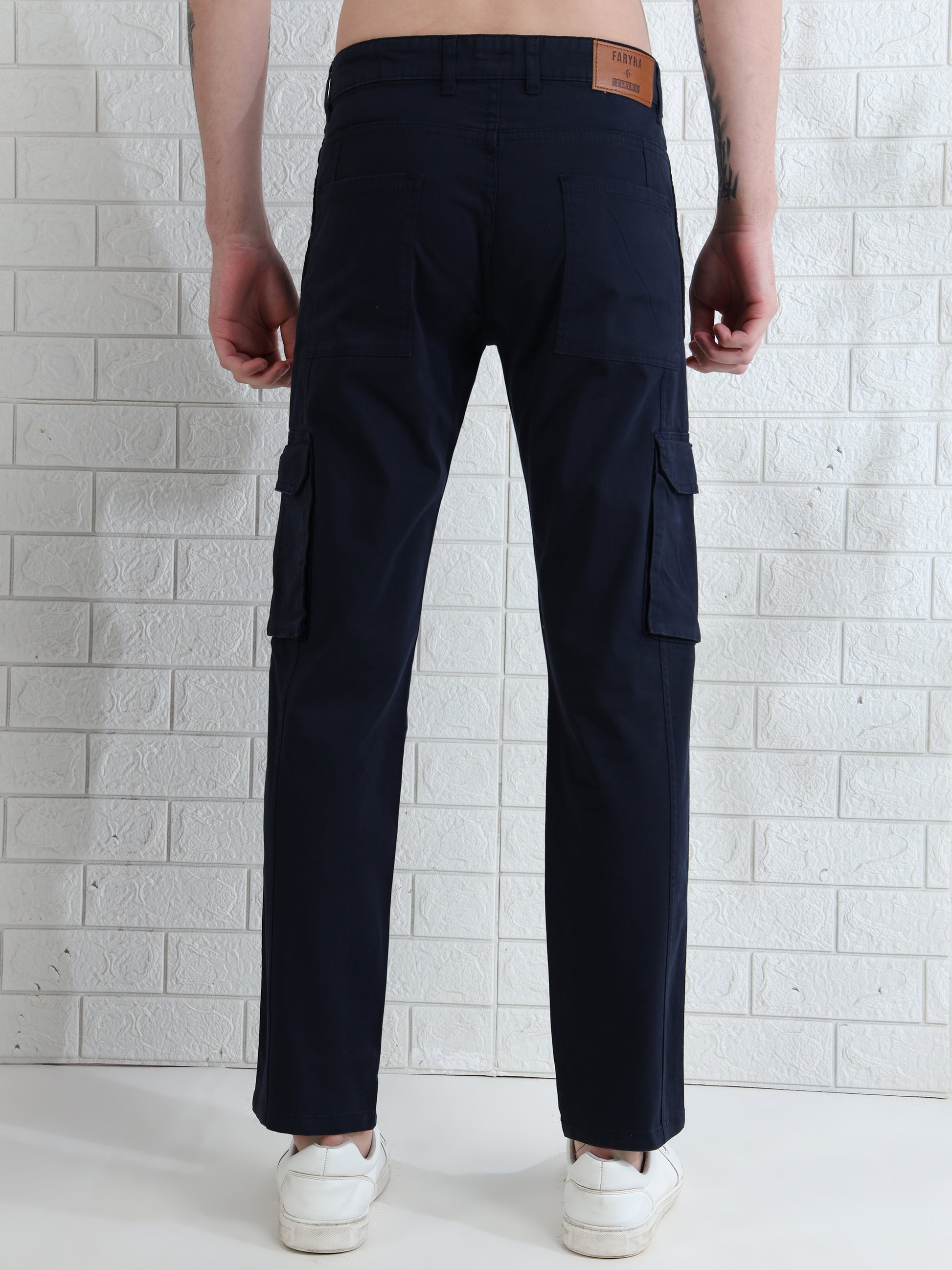 Men's navy blue cotton cargo pants with side flap pockets and slim fi