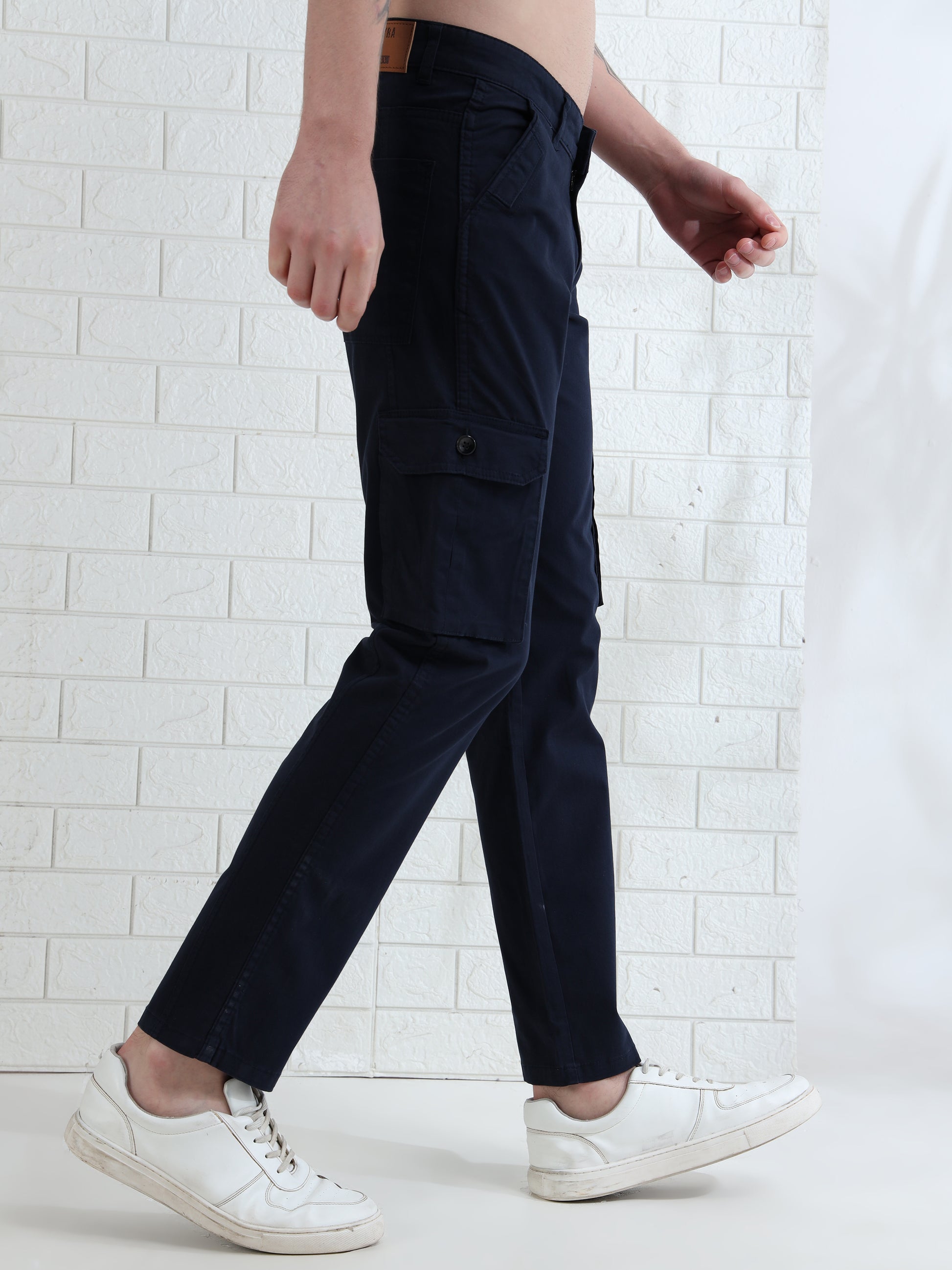 Casual men's navy cargo pants paired with white sneakers