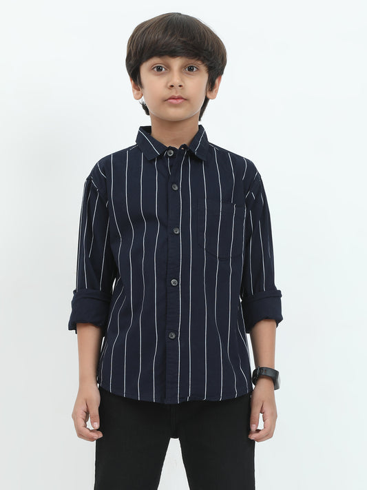 Child wearing a navy blue striped shirt on a white background