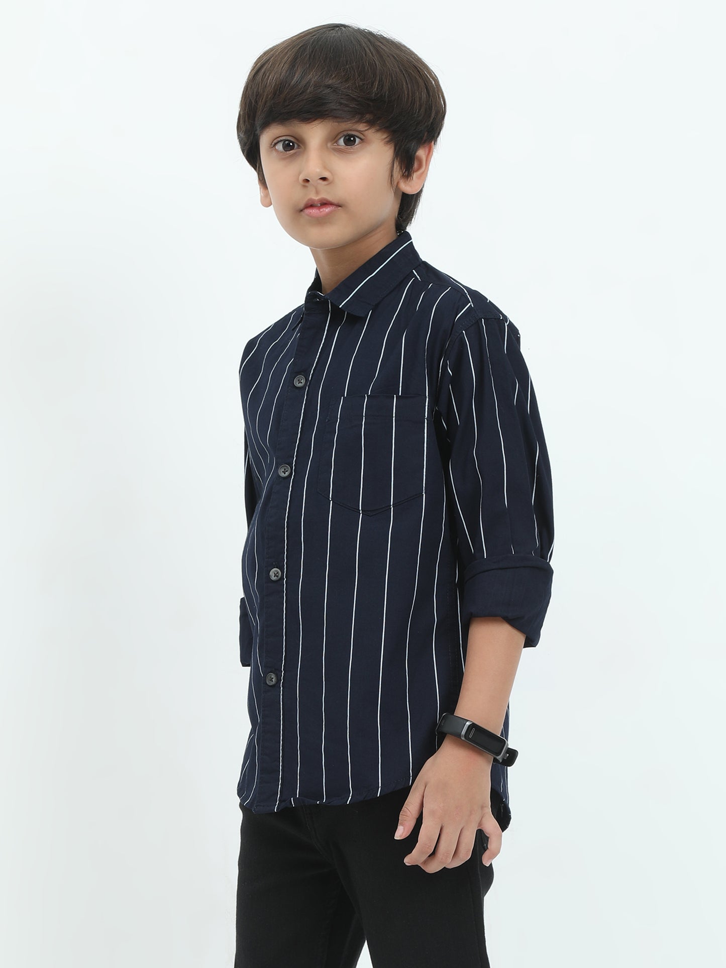 Young boy wearing a navy blue striped shirt on a white background