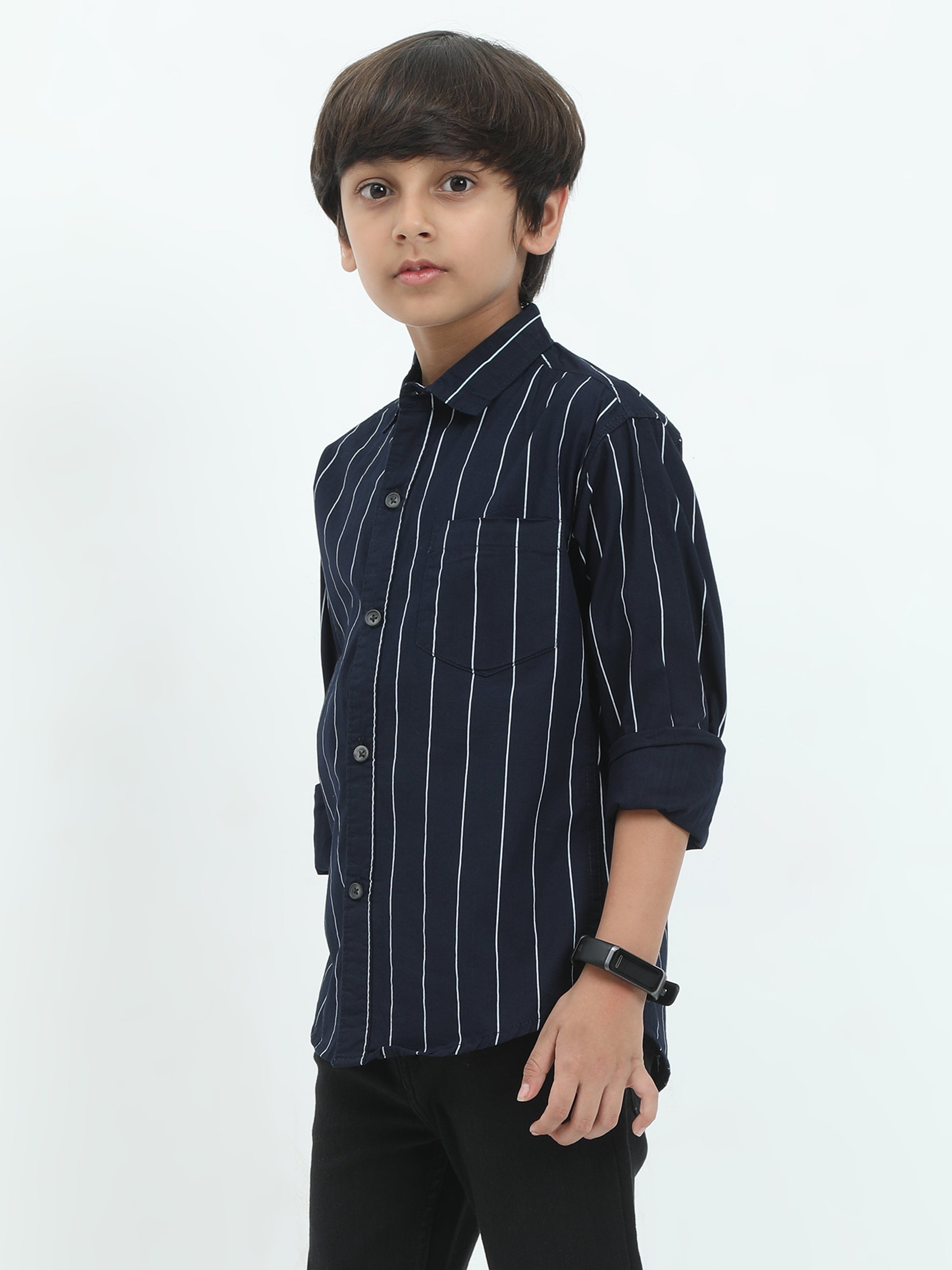 Young boy wearing a navy blue striped shirt on a white background