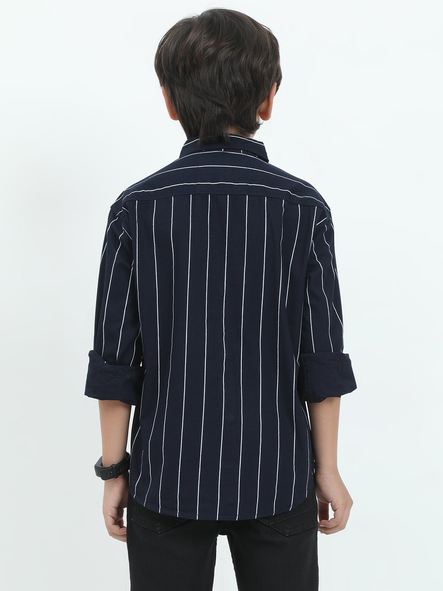 Person wearing a navy blue striped shirt with rolled-up sleeves on a white background