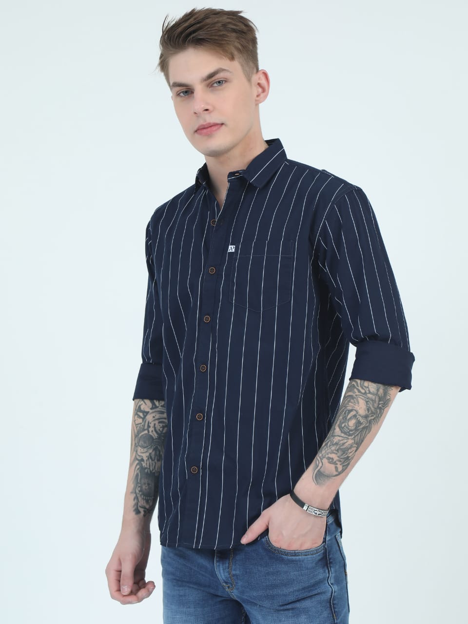 Man wearing a navy blue striped shirt on a white background