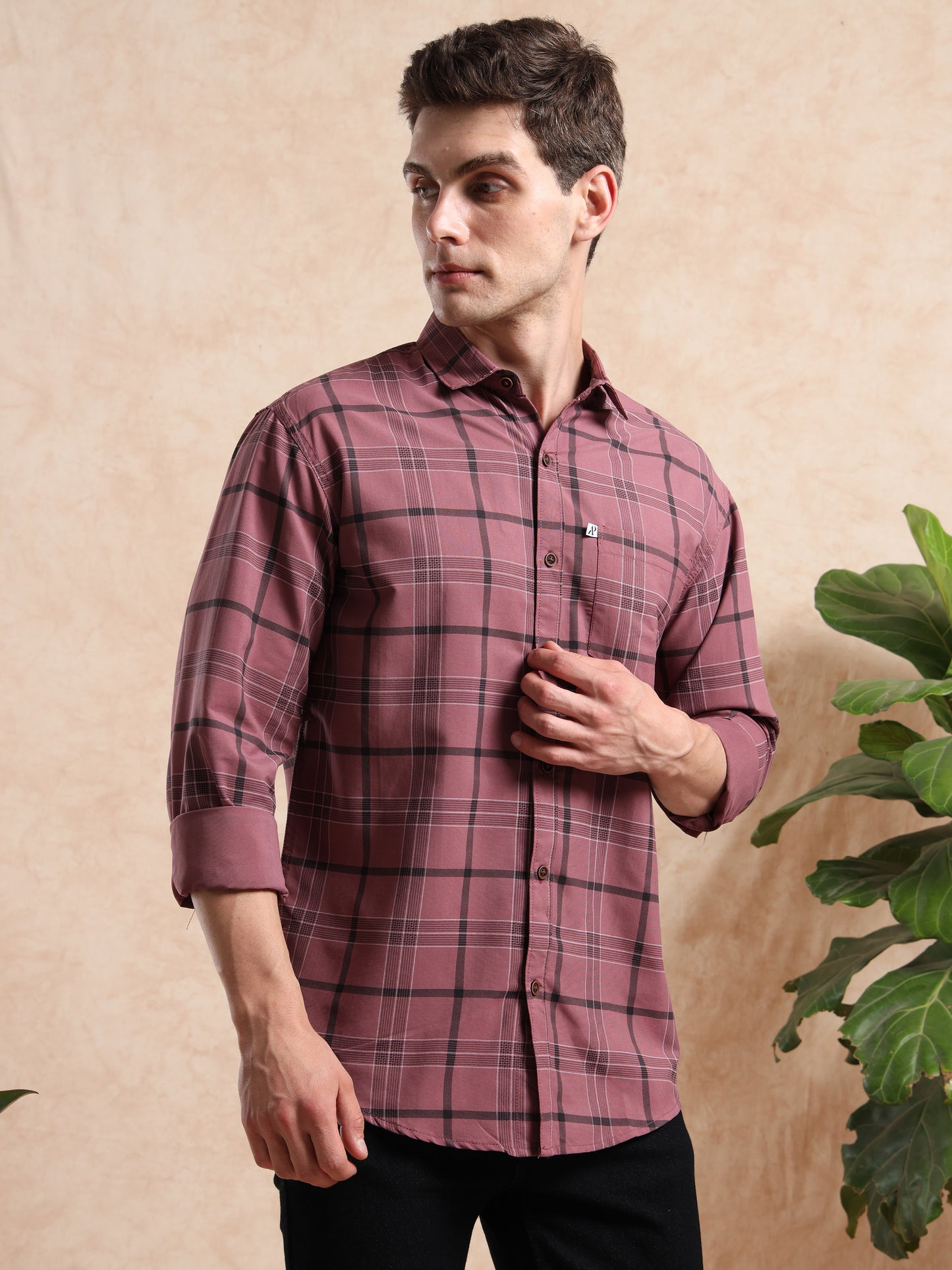 Slim fit men, maroon plaid shirt paired with black pants for a trendy casual look.