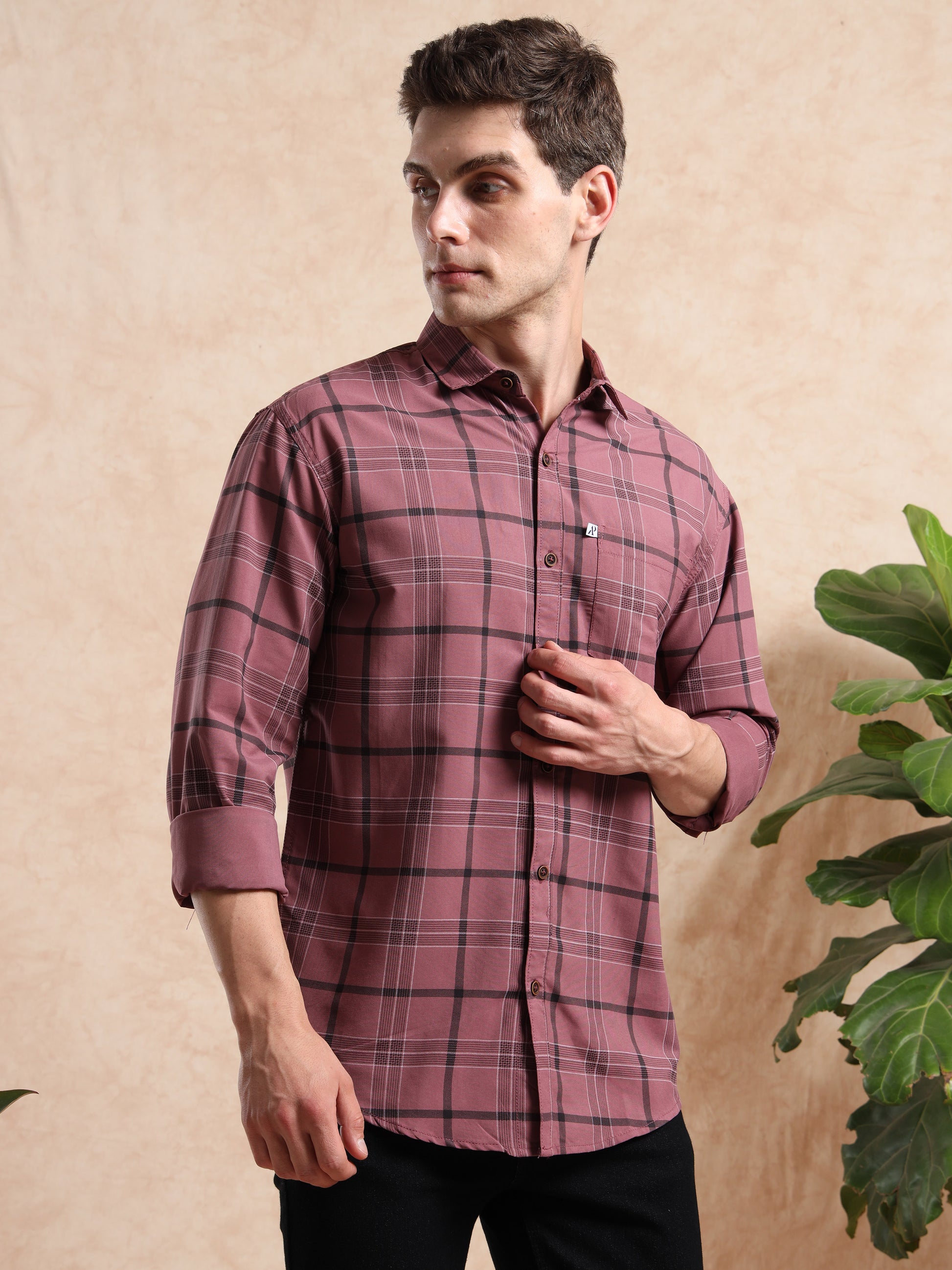 Slim fit men, maroon plaid shirt paired with black pants for a trendy casual look.