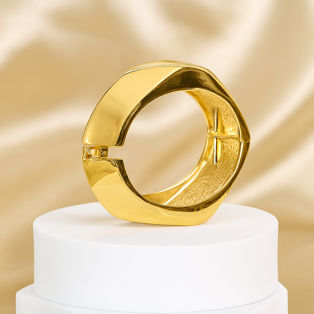 Gold ring on a white pedestal with a gold background