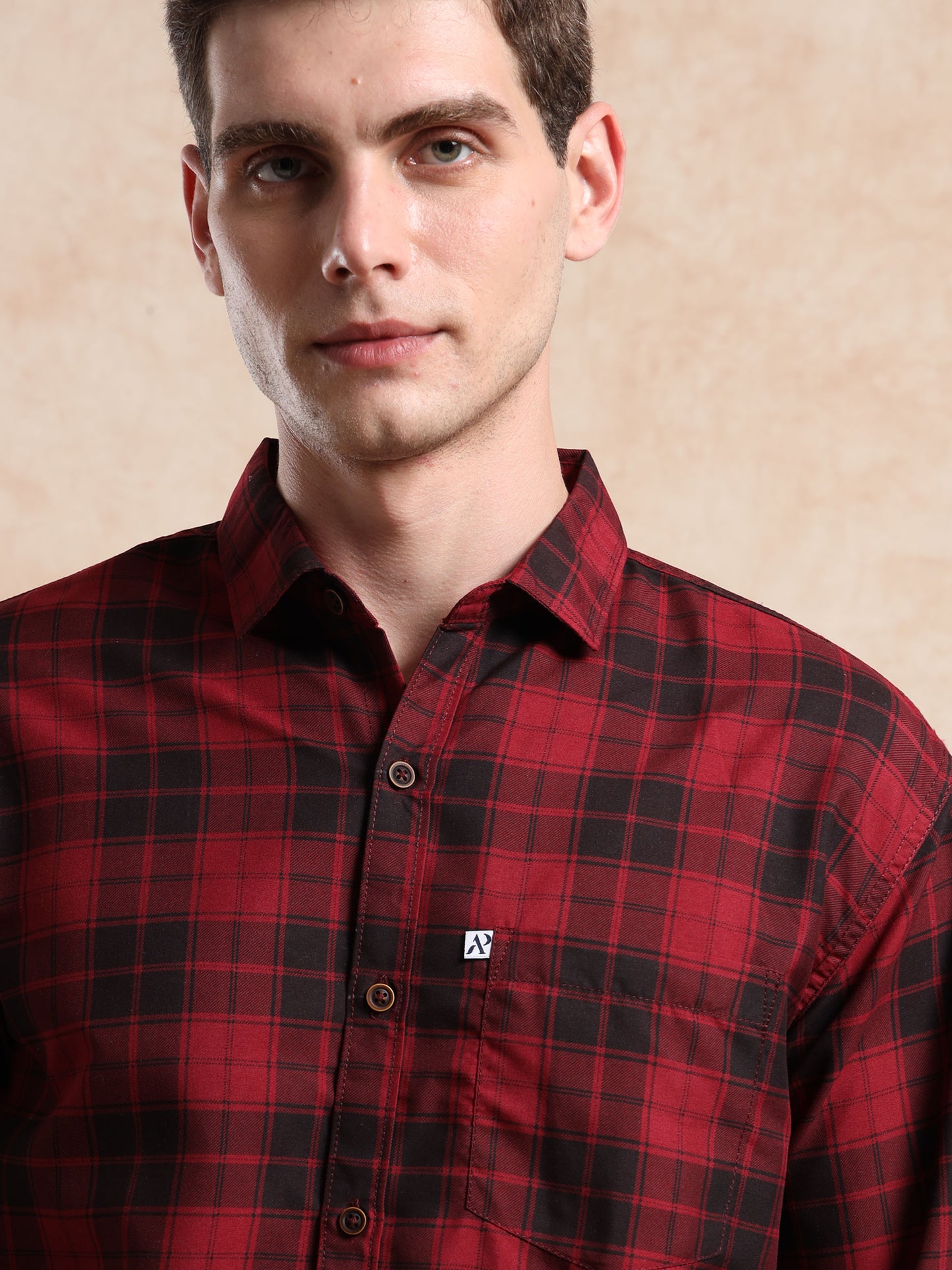 men, red and black checkered shirt with button-down collar and pocket logo detail.