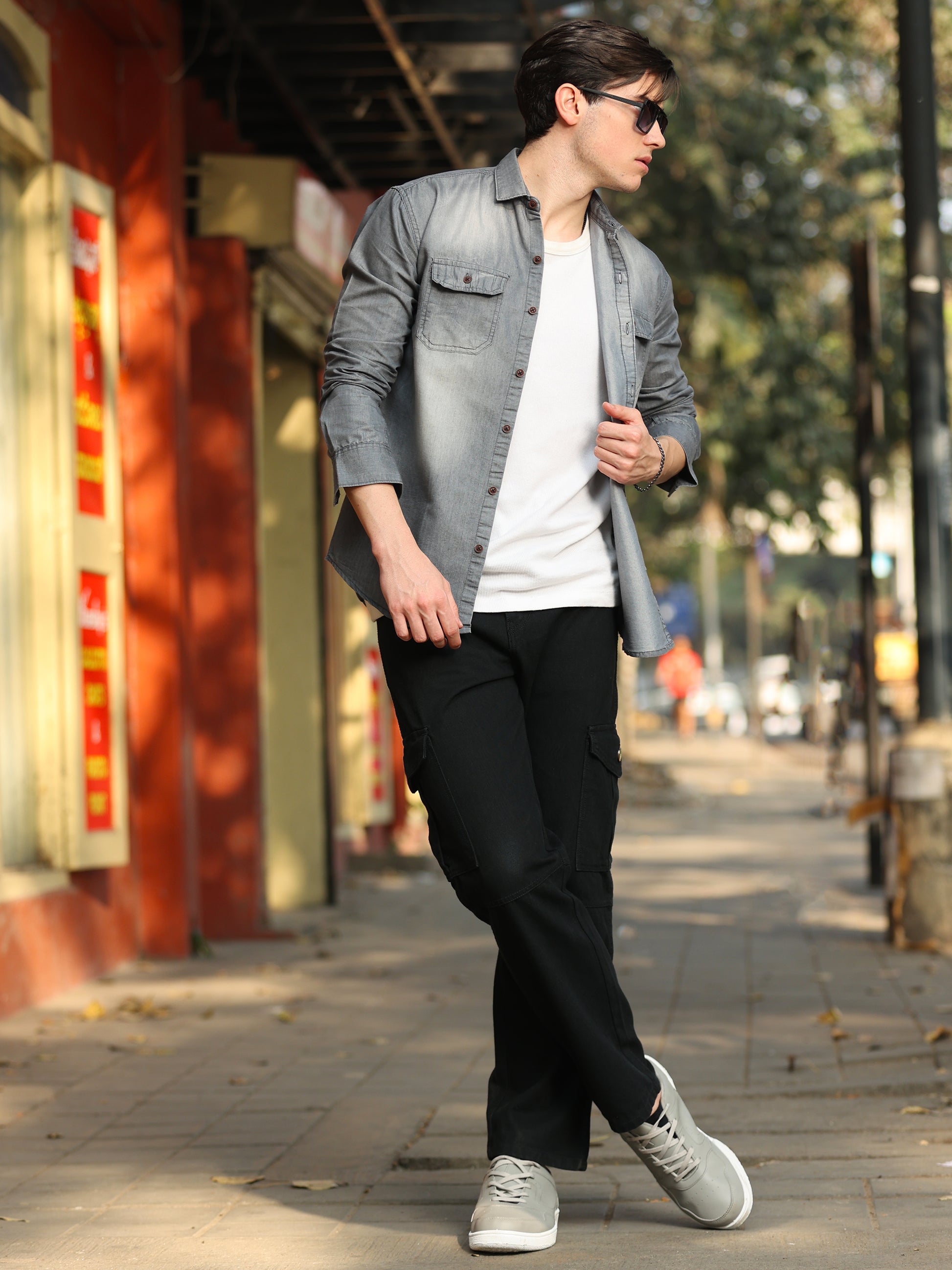 Stylish men wearing faded grey denim shirt with button-down front and modern fit