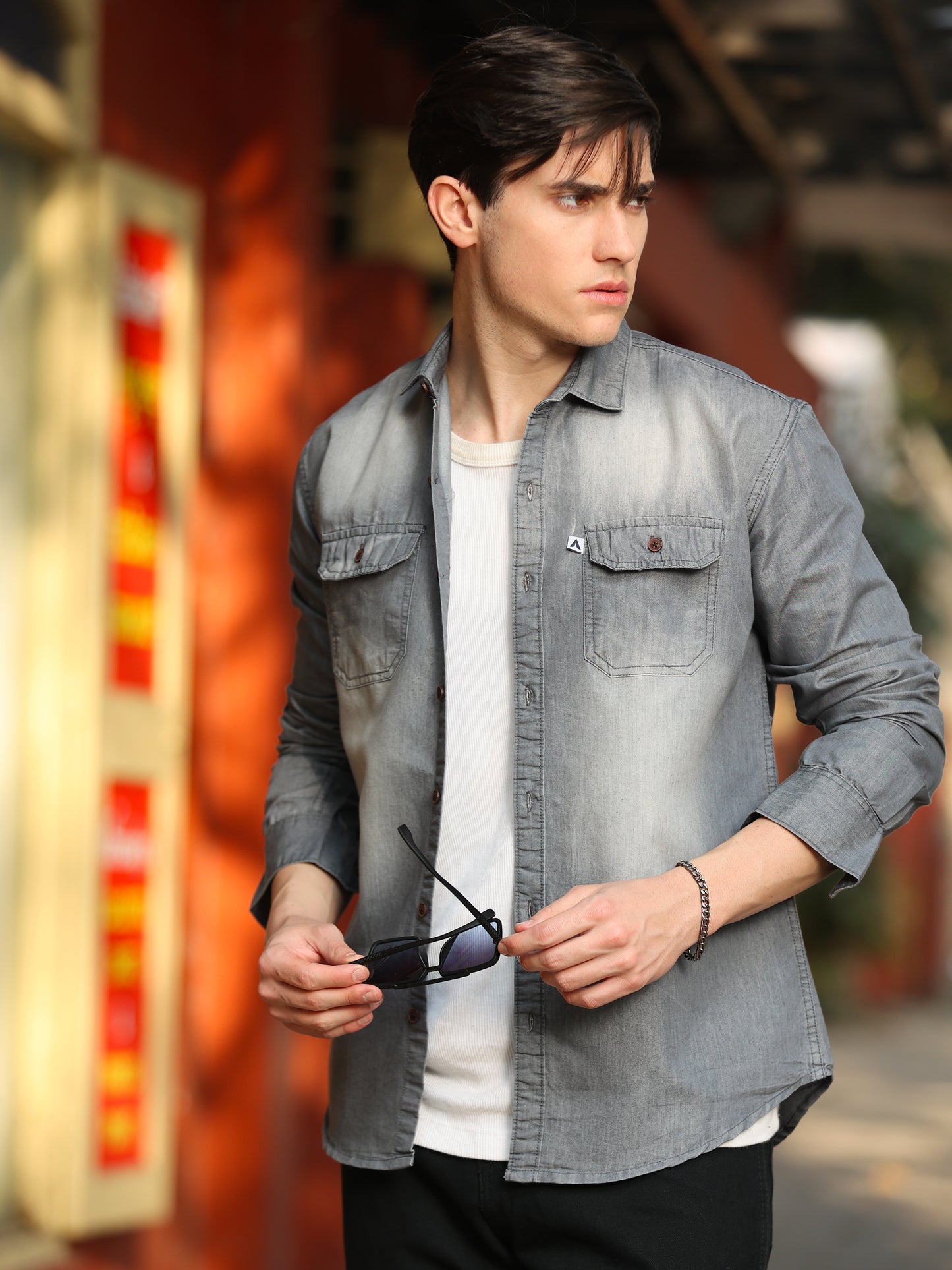 Men's light grey washed denim shirt with dual chest pockets and rolled sleeves
