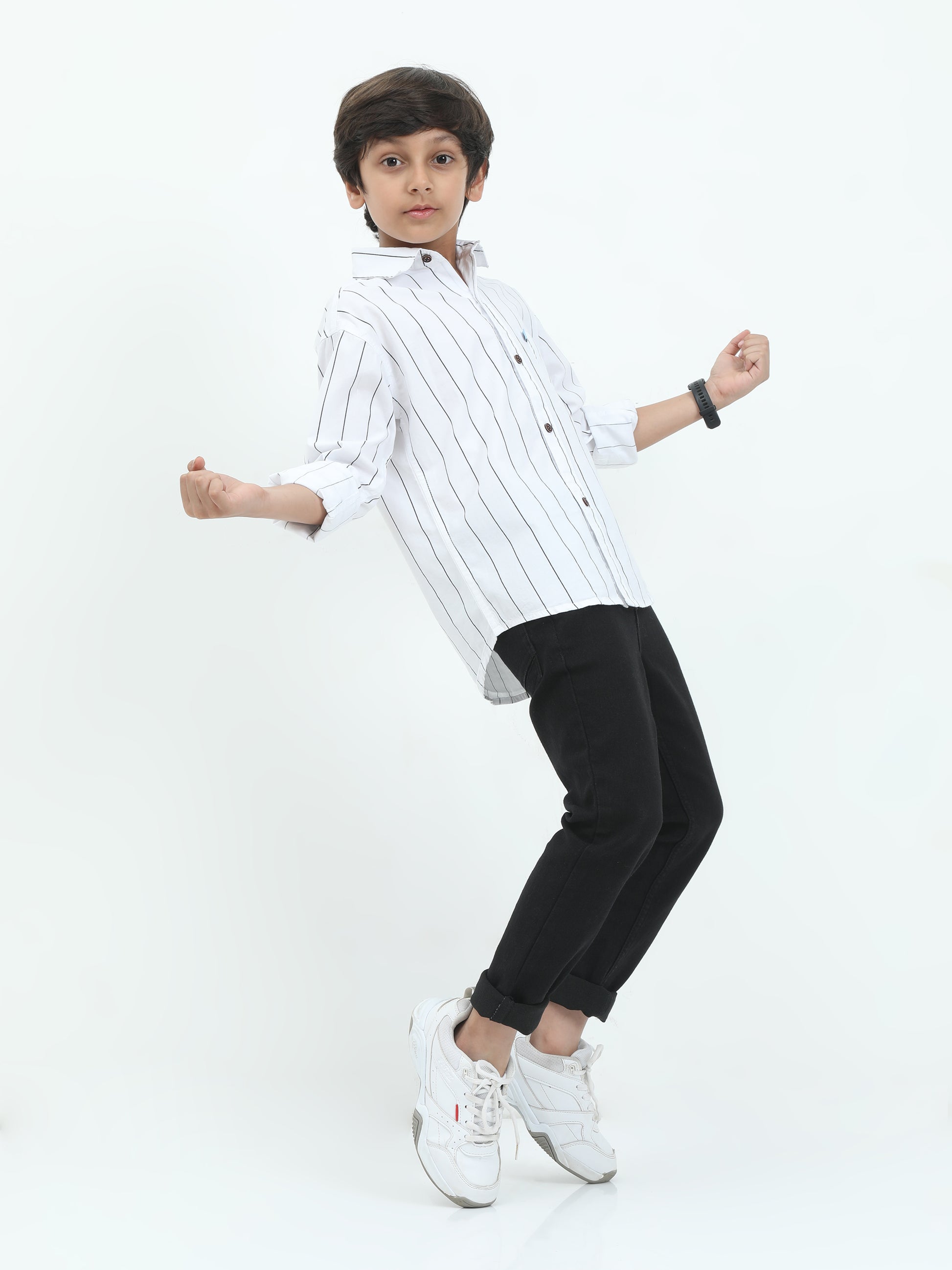 Child wearing a white striped shirt and black pants on a white background