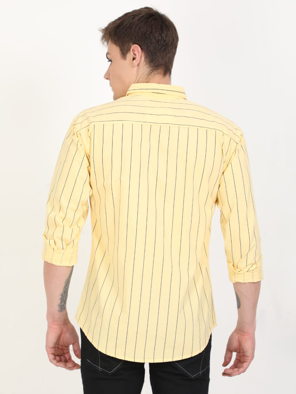 Person wearing a yellow striped shirt on a white background